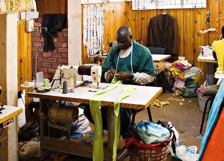 African American man working in a tailor workshopの写真素材