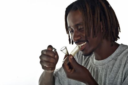 portrait of rasta man smoking marijuana from a pipe の写真素材