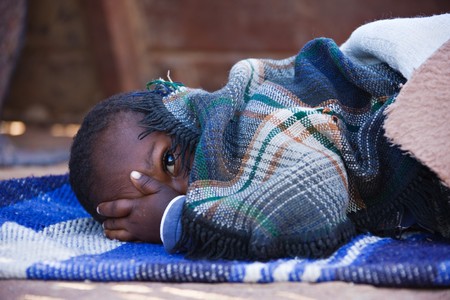 Portrait of African child sleeping in the yard , location Mmankodi village , Botswana