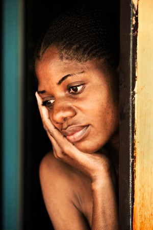 poor african woman in the door, village near Kalahari desert, Botswanaの写真素材