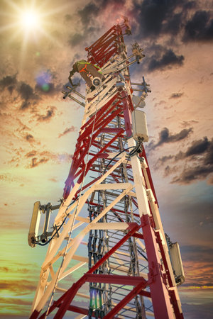African man inspecting and performing maintenance on a cellphone towerの写真素材