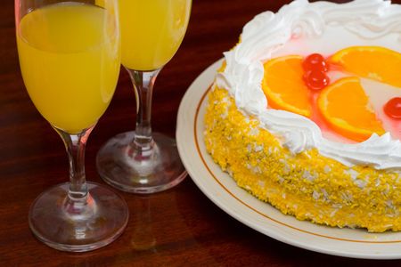 Pie on a table with two glasses of juiceの写真素材