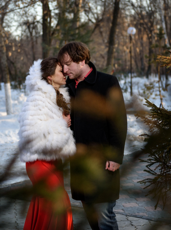 Farewell to a young couple in a winter parkの写真素材