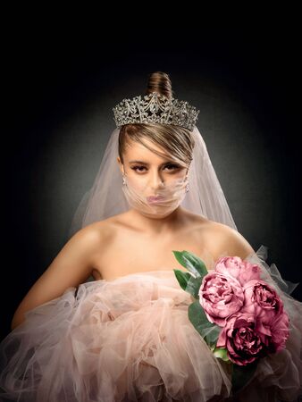Girl in a transparent medical mask with a pink veilの写真素材