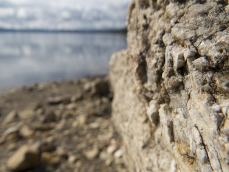 Rock by the lake shoreの写真素材