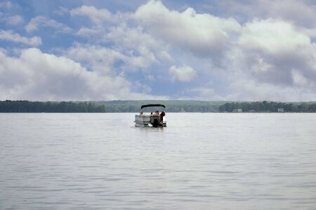 a pontoon floating on a summer lakeの写真素材