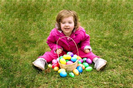 a little girl with a basket of easter eggs