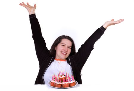 a lady celebrating her birthday with cupcakes and candles