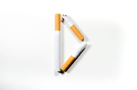 Cigarettes folded in the shape of the letter D on a white background