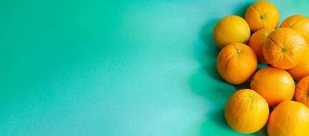 horizontally and lefted arranged oranges on a blue backgroundの写真素材