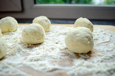 The process of cooking a folk Russian dish: the formation of ready-made products from the doughの写真素材