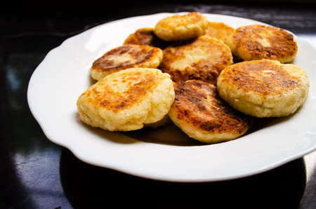 The process of cooking a folk Russian dish: putting ready-made tortillas on a plate for servingの写真素材