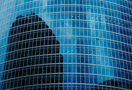 Skyscraper reflection in blue window glass