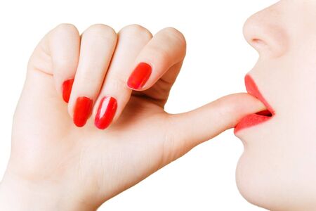 Young beautiful girl putting thumb in her mouthの写真素材