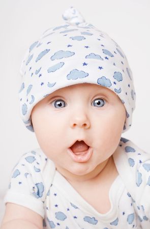 Small cute surprised child in blue pajama