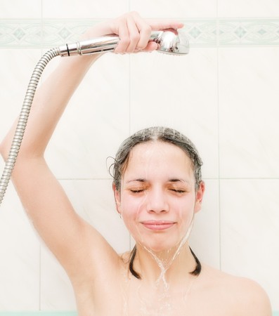 Young beautiful girl taking a showerの写真素材
