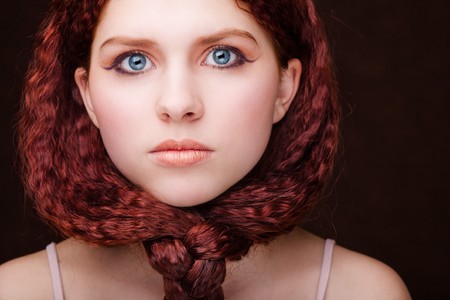 Pretty young girl with red tied hairの写真素材