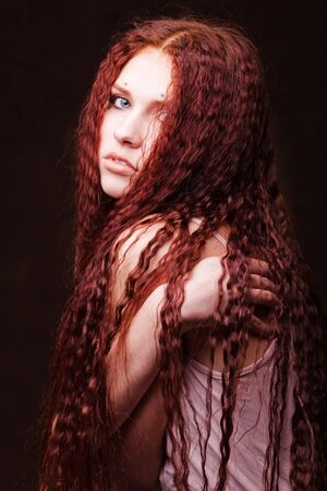 Young beautiful girl woth long red hairの写真素材