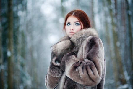 Young pretty girl with red hair in the forestの写真素材