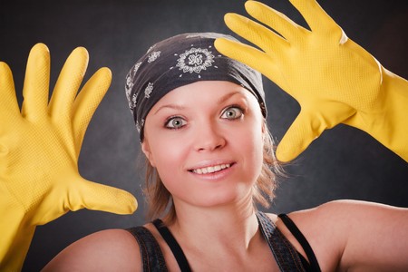 Young smiling woman with yellow rubber glovesの写真素材