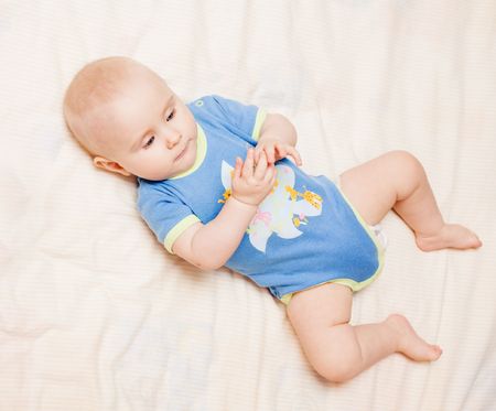 Small cute baby lying on her backの写真素材