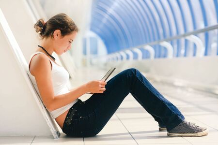 Young pretty girl sitting with a laptopの写真素材