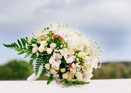 Beautiful flowers bouquet lying against sky