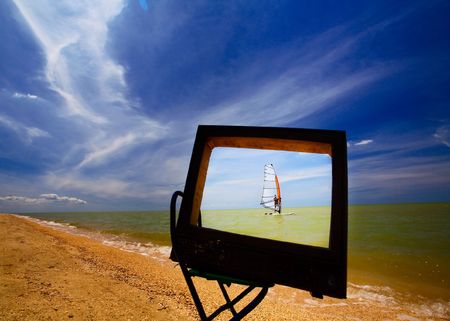 TV set standing on a sandy beachの写真素材