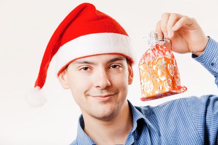 Young man in Santa hat holding a presentの写真素材