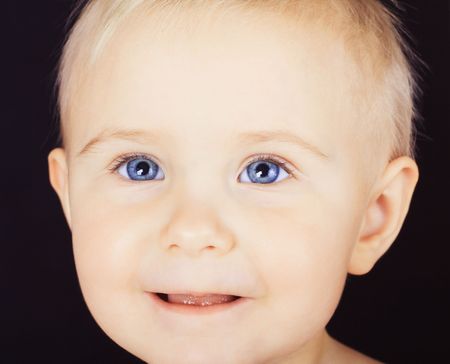 Small pretty girl with blue eyes portraitの写真素材