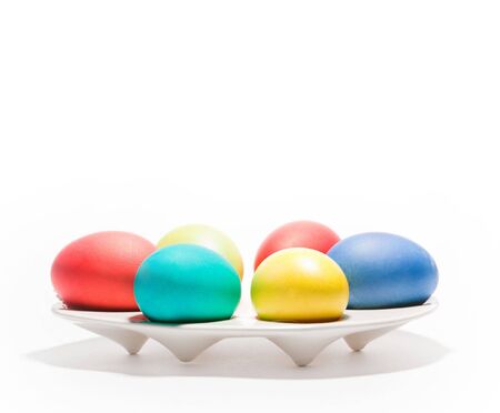 Six colorful eggs lying on white backgroundの写真素材