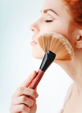 Young girl with a brown brushの写真素材