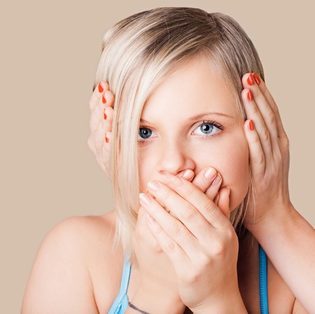 Young girl with closed mouth and earの写真素材