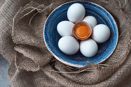 Ecological natural fresh eggs collected in the plate for cooking on the fabric.の写真素材