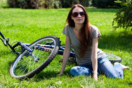 	Woman with bike outdoorsの写真素材