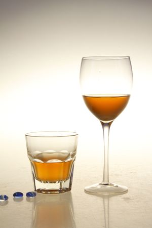 Glass and globet with transparent champagne liquid and blue glass beadsの写真素材