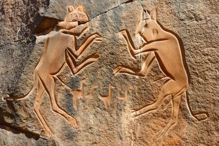 Iconic Engraving of 'The Fighting Cats' (Meercatze) at Wadi Mathendous Archeological Site, Sahara, Libya - UNESCO World Heritageの写真素材