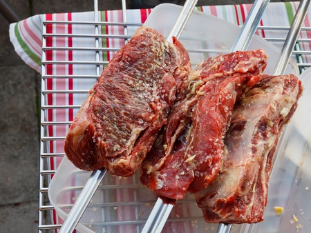 Churrasco - Brazilian style barbecue. Salted beef on skewers ready to be put onto  the grill.の写真素材