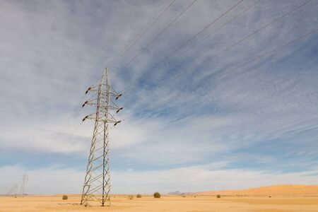 Power lines and pylon in the desert.の写真素材
