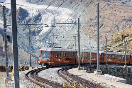 ZERMATT, SWITZERLAND - SEP 17: The Gornergratbahn, a narrow gauge mountain rack railway, approaches...