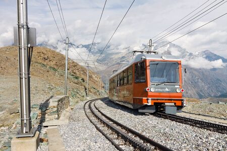 ZERMATT, SWITZERLAND - SEP 17: The Gornergratbahn, a narrow gauge mountain rack railway, approaches...