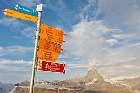 Signpost at Matterhorn, Switzerland, with directions to various hiking trails.のeditorial素材