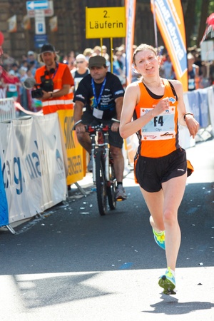 MAINZ, GERMANY - MAY 8: Olga Kotovska of the Ukraine crosses the finish line second fastest at the Gutenberg Marathon on May 8, 2011 in Mainz, Germany. 9,500 runners participate in the event.のeditorial素材
