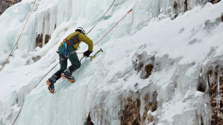 PRAGS, ITALY - JANUARY 27: An ice climber works his way up a frozen waterfall on January 27, 2012, near Prags, Italy. Ice climbing is one of the most popular sports in winter in this area.のeditorial素材