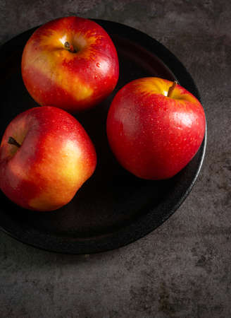 Apples in a dramatic low key concept with a dark background suitable for multipurposeの写真素材