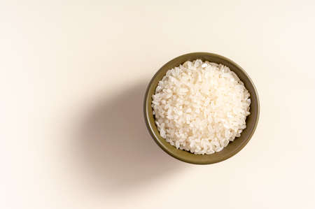 Raw rice assortment in bowl on white background. Horizontal. Place for text. Top view.の写真素材