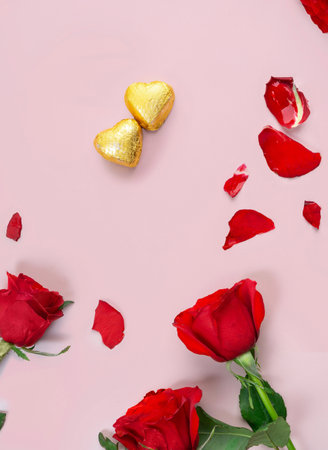 Variety of gifts and chocolates in the shape of a golden heart isolated pink background. Valentine's concept.の写真素材