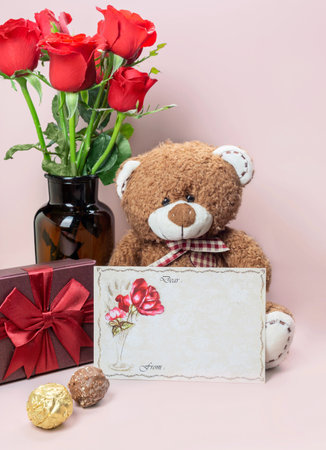 Variety of gifts and chocolates in the shape of a golden heart isolated pink background. Valentine's concept.の写真素材
