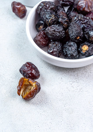 Raw Organic Arabic Dates, Ajwa Dates on light gray background. Ramadan Kareem. Close up.の写真素材