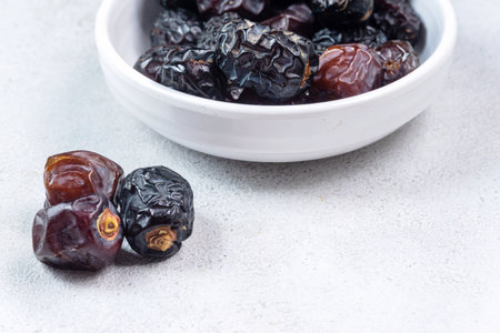 Raw Organic Arabic Dates, Ajwa Dates on light gray background. Ramadan Kareem. Close up.の写真素材